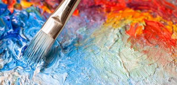 Paintbrush with oil paint on a classical palette. Do artist's tools affect their artwork?