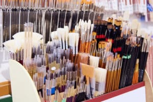 Assortment of Artist's paintbrushes on display shelf.