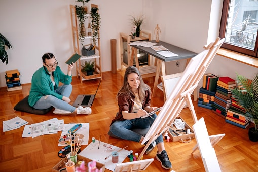 Friends painting together taking an online class.