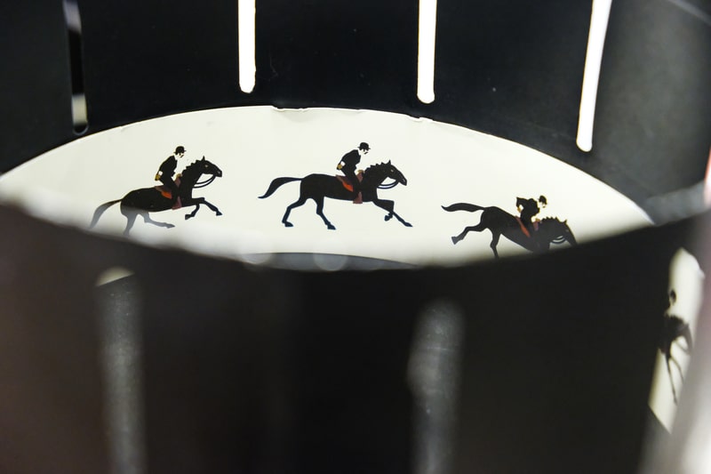 A zoetrope is film animation devices that produce the illusion of motion by displaying motion of drawings.