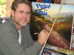 Jerry Yarnell smiling while painting on canvas.